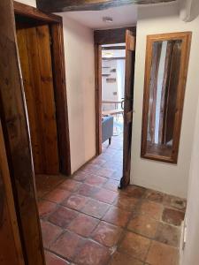 a hallway with a door and a tile floor at Dairy Cottage in Hennock
