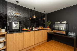 a kitchen with a counter with a tv on it at A Place Antwerp - Boutique Hotel Emile in Antwerp