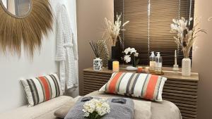 a bedroom with a bed and a table with flowers at Domaine de Roque Haute in Portiragnes +3 photos