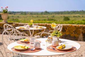a white table with plates of food on it at Domaine de Roque Haute in Portiragnes