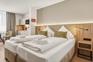 a bedroom with two beds in a room at Colleen Apartments Wesertal in Porta Westfalica