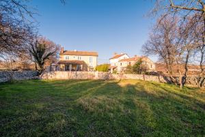 a large house with a stone wall and a yard at Villa Garica in Garica