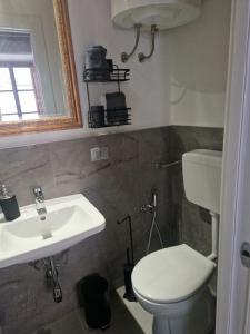 a bathroom with a toilet and a sink at DuomoHome1 in Pietrasanta