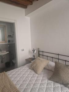 a bedroom with a bed and a sink and a mirror at DuomoHome1 in Pietrasanta +3 photos