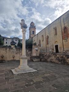 a stone pillar in front of a building at DuomoHome1 in Pietrasanta
