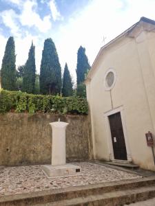 a church with a statue in front of a wall at DuomoHome1 in Pietrasanta