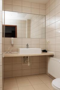 a bathroom with a sink and a toilet at Hotel 4x4 in Rivne +100 photos