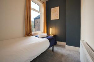 a bedroom with a bed and a window at 3-Bed Home Perfect for Exploring Nottingham & Derby in Long Eaton