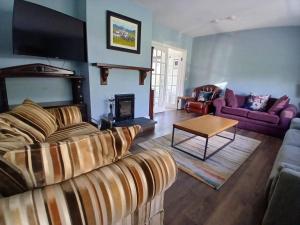 a living room with a couch and a table at The Coast House in Kilmore