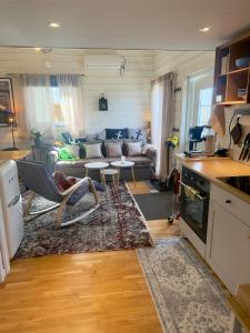 a living room with a couch and a table at Hills Cottage Holiday Homes in Gränna