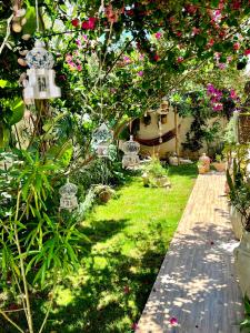a garden with pink flowers and a pathway at Sweet Home in Ariana