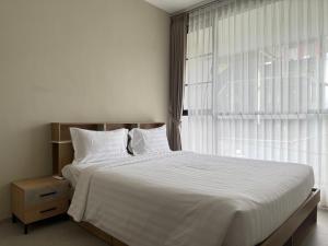 a bedroom with a large bed and a large window at Villa Grand Metro in Batu +15 photos