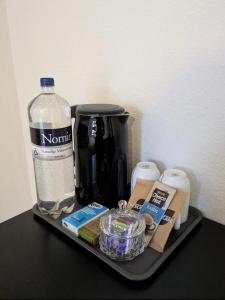 a tray with a coffee maker and a bottle of water at 13min boxen, Legoland43min, MCH10min in Herning