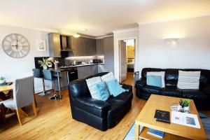 a living room with a couch and a table at Harbourside View Whitby in Whitby