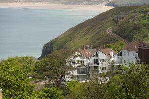 a house on the side of a hill next to the ocean at Fairsky - Sea Views and Allocated Parking in Carbis Bay