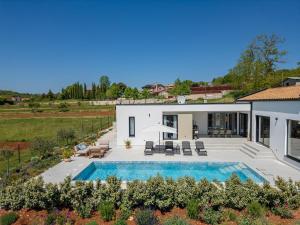 an aerial view of a house with a swimming pool at Villa Modrić by IstriaLux in Trviž