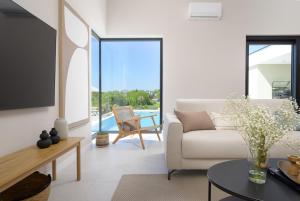 a living room with a couch and a table at Villa Modrić by IstriaLux in Trviž
