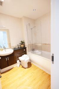 a bathroom with a toilet and a sink at Harbourside View Whitby in Whitby +30 photos