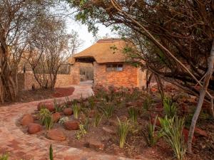a brick house with a garden in front of it at Nyala Lodge in Rayton