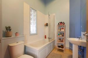 a bathroom with a tub and a toilet and a sink at Raleigh Loft in Nottingham