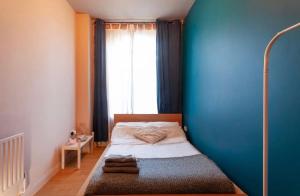 a bedroom with a bed with a blue wall at Raleigh Loft in Nottingham
