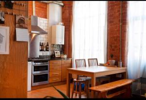 a kitchen with a table and a stove top oven at Raleigh Loft in Nottingham +9 photos
