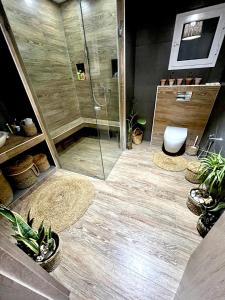 a bathroom with a shower and a toilet and plants at Sweet Home in Ariana