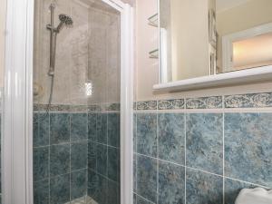 a shower with a glass door in a bathroom at The Willows in Dymchurch +16 photos
