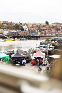 a marina with a group of tents and boats at Harbourside View Whitby in Whitby