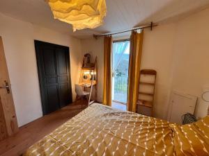 a bedroom with a bed and a large window at Charming apartment in Nyons in Nyons