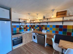 a kitchen with colorful tiles on the wall at Charming apartment in Nyons in Nyons