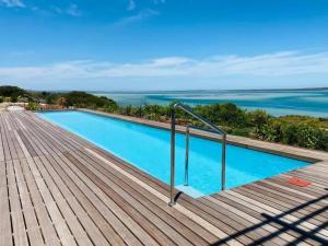 a swimming pool with a view of the ocean at The Shark Bay Boutique Hotel & Spa in Langebaan +25 photos