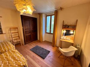 a bedroom with a bed and a desk and a chair at Charming apartment in Nyons in Nyons