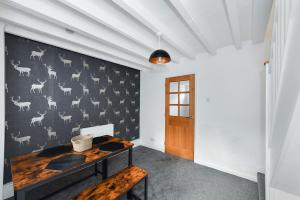 a room with a wall with a painting of animals at Newark Central Cottage in Newark-on-Trent