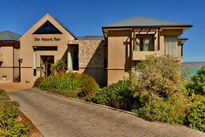 a house with a cobblestone road in front of a building at The Shark Bay Boutique Hotel & Spa in Langebaan