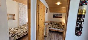 a small room with two beds in a room at Wakacyjny Dom Dawidówka in Wisła
