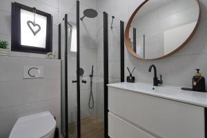 a bathroom with a shower and a sink and a mirror at taira suite in Rosh Pinna +21 photos