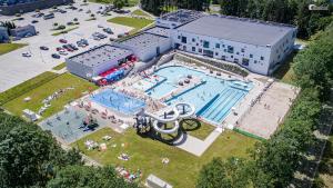 an overhead view of a large swimming pool and a building at Tani skosik w MOSiRze in Sanok