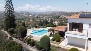 a villa with a swimming pool and a house at Mountain view 6 bed mansion with Private Padel Court, Pool & Gym in Larnaca
