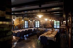 a long dining room with long tables and chairs at Kupiškio marių vila in Aukštupėnai +63 photos