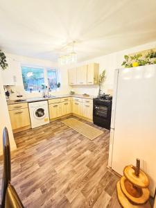 a kitchen with wooden floors and a white refrigerator at Central Hideout in Birmingham