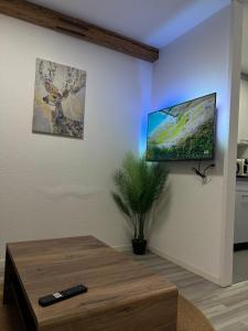 a living room with a coffee table and a painting on the wall at Rawda Ferien Wohnung 2 in Interlaken
