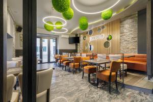 a restaurant with tables and chairs and a bar at Guest House Jezero in Most na Soči