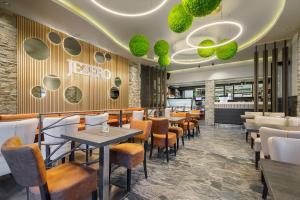 a restaurant with tables and chairs and a bar at Guest House Jezero in Most na Soči