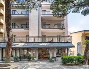 an external view of a hotel with a building at Hotel Altamarea in Misano Adriatico