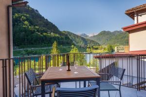 a table and chairs on a balcony with a view at Guest House Jezero in Most na Soči