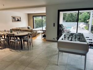 a living room with a foosball table and chairs at villa des gorges in Vagnas