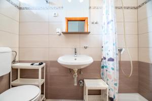a small bathroom with a sink and a toilet at Bed & Breakfast Haus Lucija in Baška +145 photos