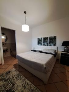 a bedroom with a large bed and a pendant light at GR room 22 in Sennori