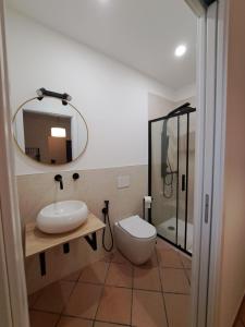 a bathroom with a sink and a toilet and a mirror at GR room 22 in Sennori